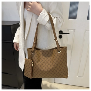 Detail view of large brown vintage tote bag with geometric pattern and coin purse