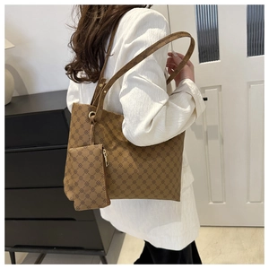 Detail view of large brown vintage print tote bag with matching small zippered clutch pouch