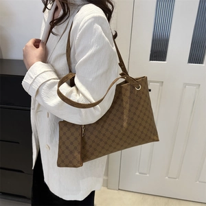 Retro brown printed tote bag with matching small pouch shown as a shoulder bag