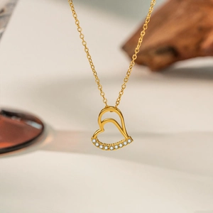 Macro shot of double heart pendant necklace with shimmering white crystal inlay