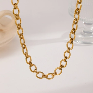 Close-up of elegant gold plated stainless steel cable chain necklace with polished finish