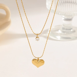 Elegant 18K gold double layer necklace featuring a heart pendant and zircon stone