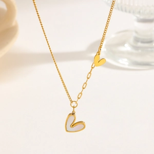 Asymmetric heart necklace with white mother of pearl inlay and gold tone layered chain