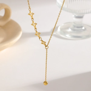 Detail of Y-shaped gold titanium necklace with hollow star charms and a drop pendant