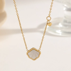 Elegant gold starfish seashell necklace with iridescent shell pendant and heart charm