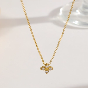 Elegant gold titanium steel necklace with a four-leaf clover pendant and clear zircons