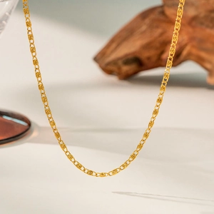 Close-up of a high-quality gold twisted rope chain necklace with a luxury polished finish
