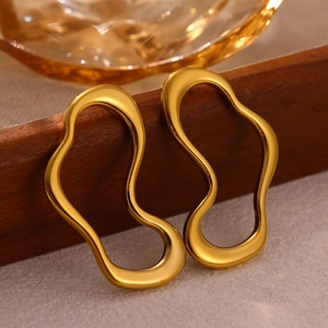 Detail of 18K gold plated irregular fluid shape earrings on a wooden tray background