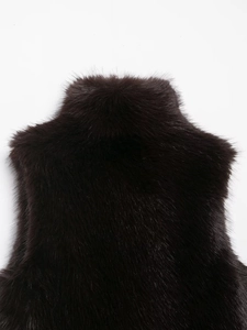 Detailed view of dark brown faux fur vest texture featuring thick high-quality fibers