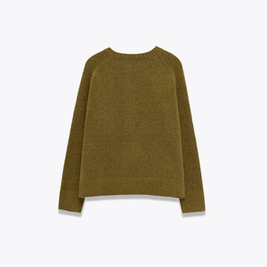 Back view of an olive green oversized knit sweater with crew neck and ribbed cuffs