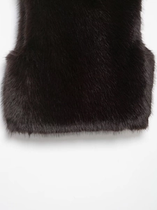 Close-up detail of the smooth faux fur texture on the hem of a black sleeveless vest