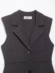 Detailed flat lay of dark grey knit vest featuring V-neck lapels and button closure