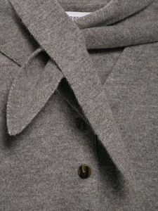 Detail of grey knitted cardigan with scarf collar and dark marble texture buttons
