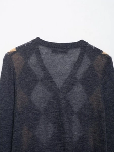 Close-up of dark grey V-neck knit cardigan with argyle shoulder patterns on white background