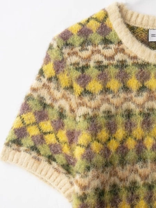 Macro view of colorful geometric jacquard knit sweater with soft fuzzy mohair texture