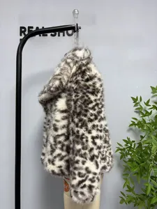 Detail shot of the long fluffy texture of a black and white leopard faux fur winter coat