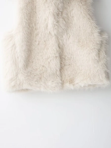 Detailed close-up of soft off-white faux fur vest featuring premium shaggy texture
