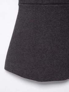 Detailed macro view of dark grey knit fabric featuring thick vertical ribbed texture