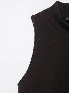 Detail of dark brown ribbed knit mock neck vest showing fabric texture and neckline tag