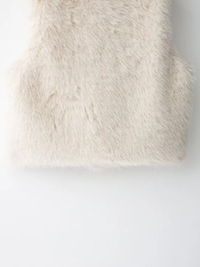 Close-up detail of plush beige faux fox fur vest showing soft texture and premium quality