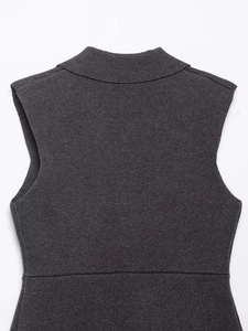 Detailed macro view of charcoal grey knit texture on a high-neck sleeveless vest