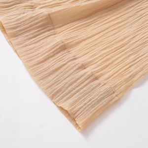 Chic apricot pleated wide-leg pants with translucent plissé texture and elastic design