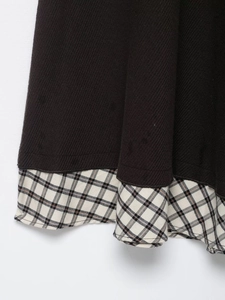 Detail shot of knitted hem with plaid fabric splicing in college style for women
