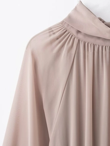 Close-up of elegant pleated high collar and bow detail on dusty pink chiffon dress