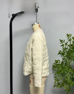 Detail view of bow-shaped quilting pattern on a light beige commuter jacket coat
