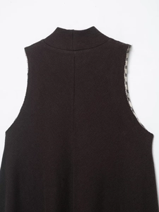 Close-up of knit dress texture with high collar and classic checkered lining detail