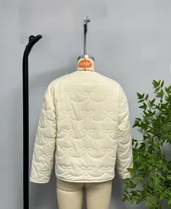 Detail of white quilted jacket featuring unique textured bow-knot stitch pattern