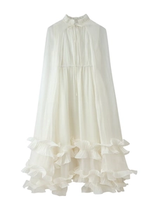 Detail of white chiffon dress showing ruffled neckline and tiered layered edges