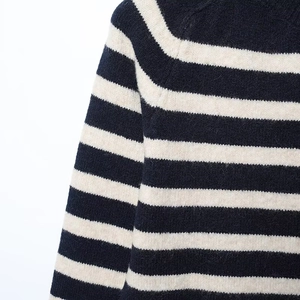 Detailed close-up showing the soft knit texture and striped pattern of the cardigan jacket