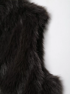 Close-up of high-density black faux fur texture on a luxury sleeveless vest