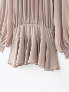 Detail view of mauve chiffon mini dress featuring fine pleats and elastic waist design