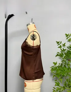Detail of brown satin camisole featuring delicate eyelash lace trim on V-neckline