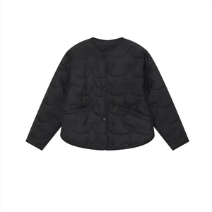 Minimalist black quilted jacket with bow pattern stitching and round neckline in a loose fit