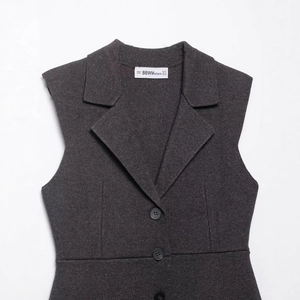 Deep grey sleeveless V-neck knit dress with wide lapels and button-up front style