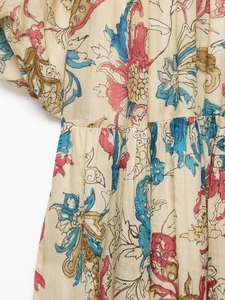 Detail of ramie fabric with floral paisley prints and pleated waist stitching on a dress