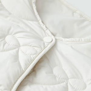 Chic cream quilted vest for women featuring clover stitching and a button collar detail