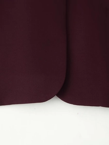 Macro detail of wine red blazer rounded hem showing premium woven fabric texture