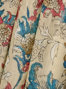 Close-up of ethnic floral ramie fabric texture on a vintage off-shoulder dress