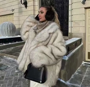 Detailed view of the elegant silver-white faux fur coat with oversized fluffy lapels