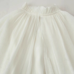 White ruffled maxi dress with elegant pleats and delicate tiered frill details
