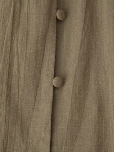 Detailed close-up of cotton linen fabric texture and elegant fabric-covered buttons