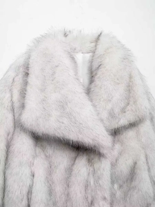 Close-up detail of soft light grey faux fur texture on elegant notched collar coat