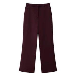 Close-up of high-waisted burgundy wide-leg trousers with elegant drape and clean waistline