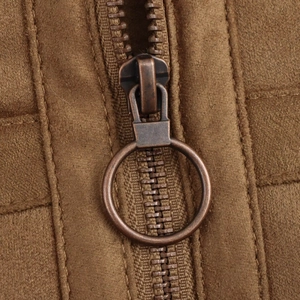 Detail of a brown faux suede jacket featuring a vintage bronze round ring zipper pull