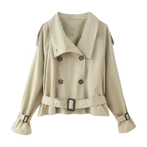 Detail of double-breasted beige short trench coat with waist belt and wide lapels