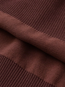 Detailed close-up of brown wool-blend knit fabric with vertical ribbed texture